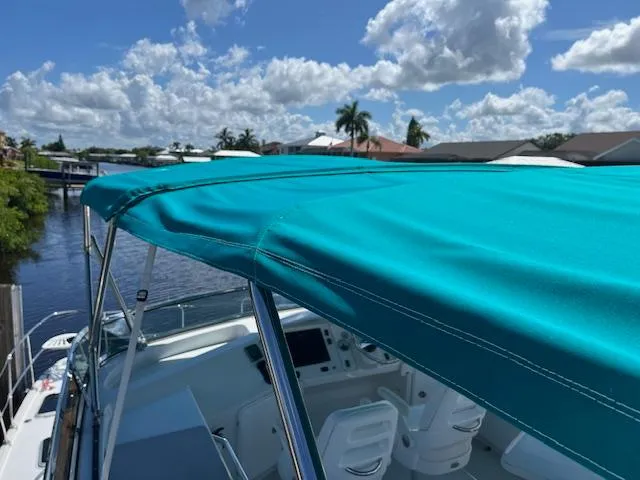 Magic Yacht Photos Pics Turquoise canopy on PDQ MV-41 boat, 2008 model, with scenic waterfront view.