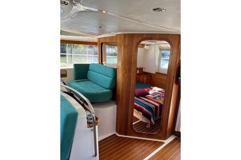 Magic Yacht Photos Pics Interior of 2008 PDQ MV-41 boat with teal seating and cozy cabin.
