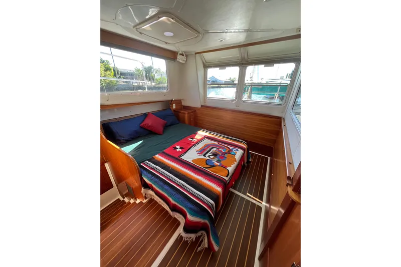 Magic Yacht Photos Pics Cozy cabin interior of 2008 PDQ MV-41 boat with colorful bedding and wood accents.