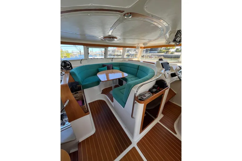 Magic Yacht Photos Pics Interior of 2008 PDQ MV-41 boat with teal seating and wooden flooring.