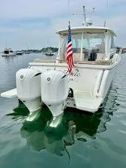 Fin & Tonic Yacht Photos Pics 2020 Back Cove 34O boat with dual outboard engines on calm water.