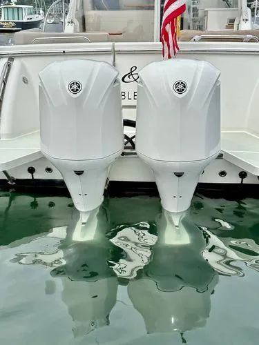 Fin & Tonic Yacht Photos Pics 2020 Back Cove 34O boat with twin outboard engines, docked in marina.