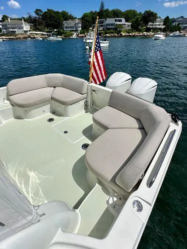 Fin & Tonic Yacht Photos Pics 2020 Back Cove 34O boat with spacious seating, American flag, and scenic waterfront view.