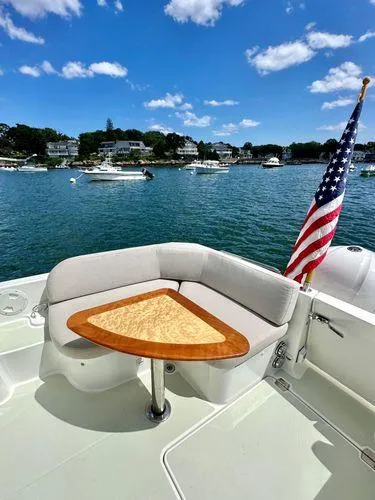 Fin & Tonic Yacht Photos Pics 2020 Back Cove 34O boat with seating area and American flag on a sunny day.