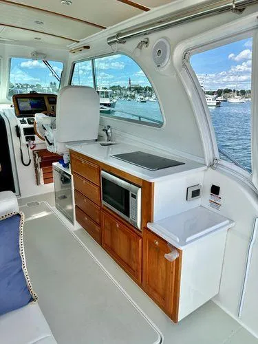 Fin & Tonic Yacht Photos Pics 2020 Back Cove 34O yacht interior with kitchenette and scenic water view.