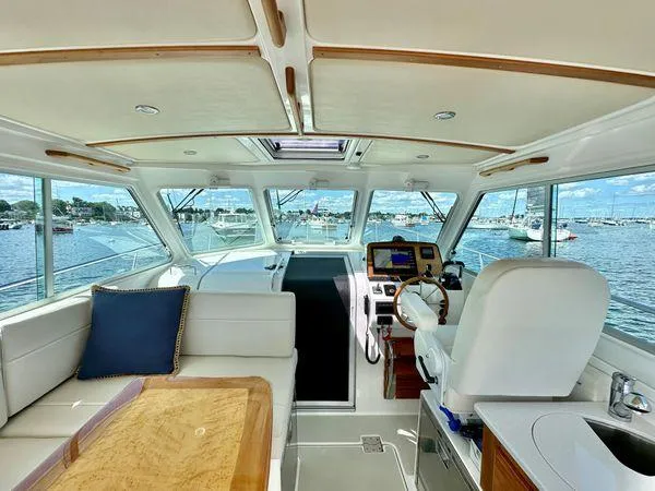 Fin & Tonic Yacht Photos Pics Interior of 2020 Back Cove 34O yacht with helm, seating, and marina view.