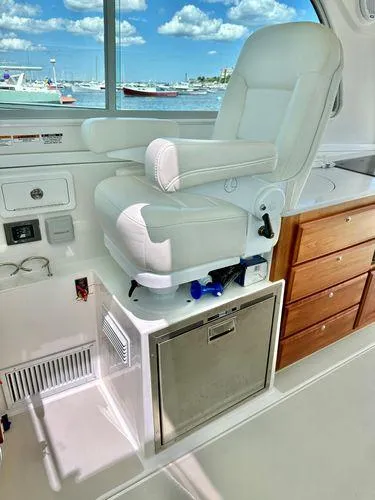 Fin & Tonic Yacht Photos Pics 2020 Back Cove 34O helm seat with storage, overlooking marina.