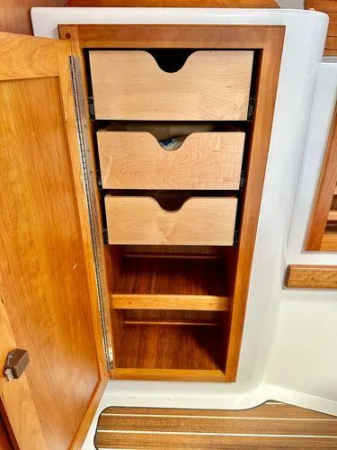 Fin & Tonic Yacht Photos Pics Wooden cabinet with three drawers in a 2020 Back Cove 34O boat interior.