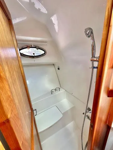 Fin & Tonic Yacht Photos Pics 2020 Back Cove 34O yacht bathroom with shower and porthole window.