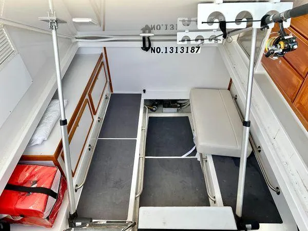 Fin & Tonic Yacht Photos Pics 2020 Back Cove 34O interior with seating, storage, and fishing rod holders.