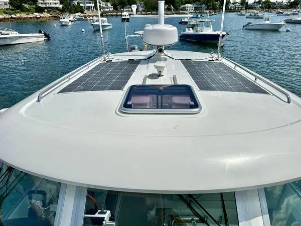 Fin & Tonic Yacht Photos Pics 2020 Back Cove 34O boat with solar panels on deck, docked in a marina.