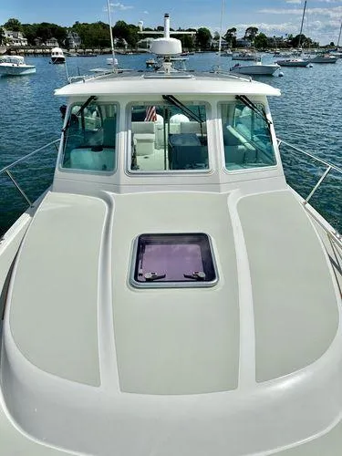 Fin & Tonic Yacht Photos Pics 2020 Back Cove 34O boat on water, showcasing sleek design and spacious deck.