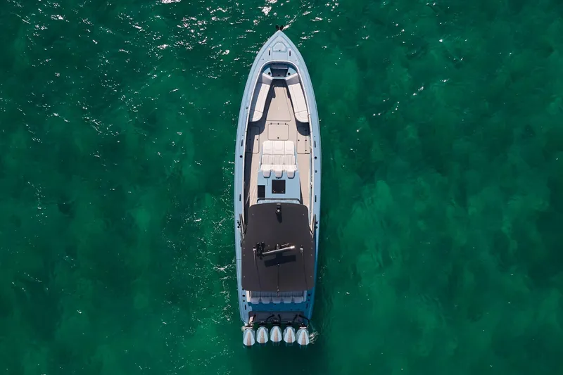  Yacht Photos Pics Aerial view of 2023 Midnight Express 43' Open boat on clear turquoise water.