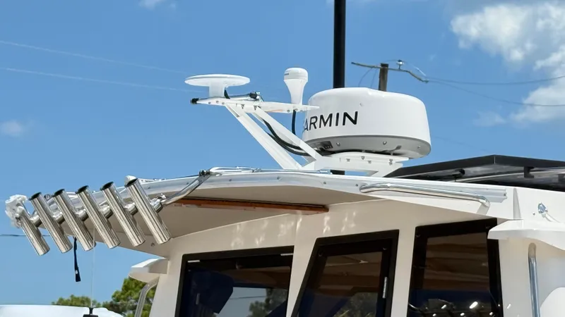  Yacht Photos Pics 2026 Cutwater C-288 Coupe with Garmin radar and rod holders under clear sky.