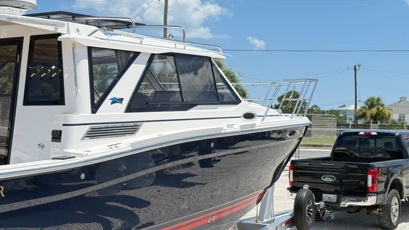  Yacht Photos Pics 2026 Cutwater C-288 Coupe boat on trailer, parked beside a black Ford truck.