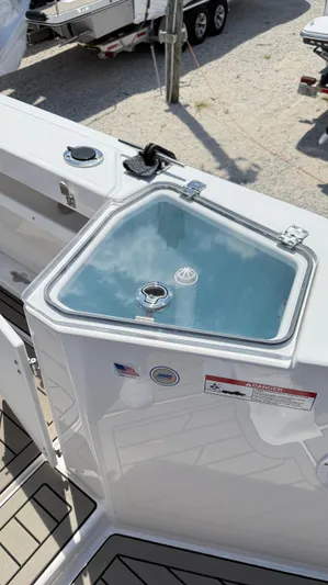  Yacht Photos Pics 2026 Cutwater C-288 Coupe boat deck with storage compartment and safety labels.