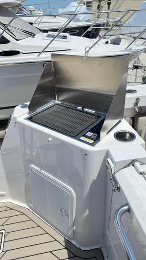  Yacht Photos Pics Outdoor grill on 2026 Cutwater C-288 Coupe boat deck, featuring stainless steel finish.