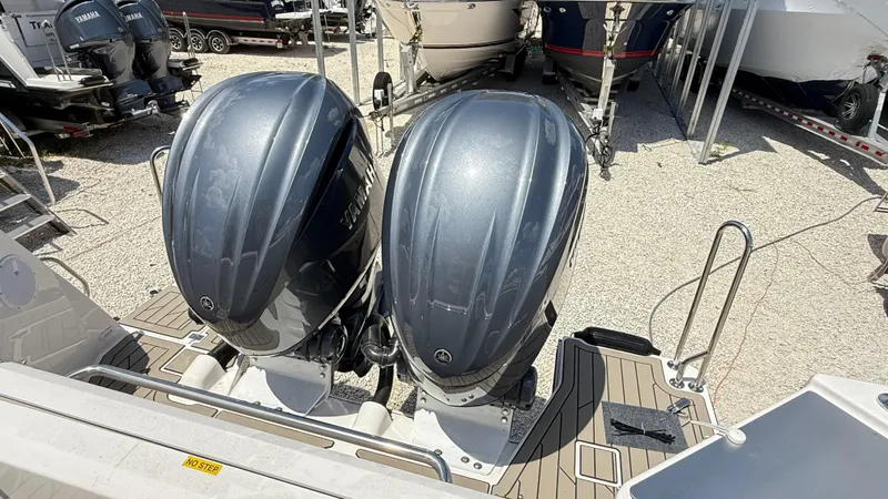  Yacht Photos Pics 2026 Cutwater C-288 Coupe with dual Yamaha outboard engines, displayed on a gravel lot.