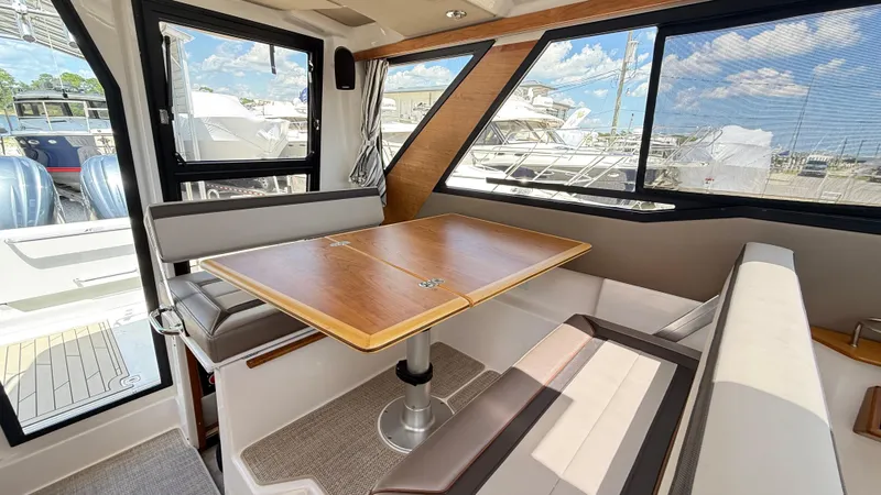  Yacht Photos Pics Interior of 2026 Cutwater C-288 Coupe with dining area and large windows.