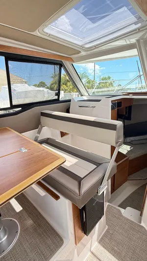  Yacht Photos Pics 2026 Cutwater C-288 Coupe interior with seating, table, and skylight.