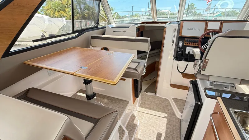  Yacht Photos Pics Interior of 2026 Cutwater C-288 Coupe boat with dining area and helm.