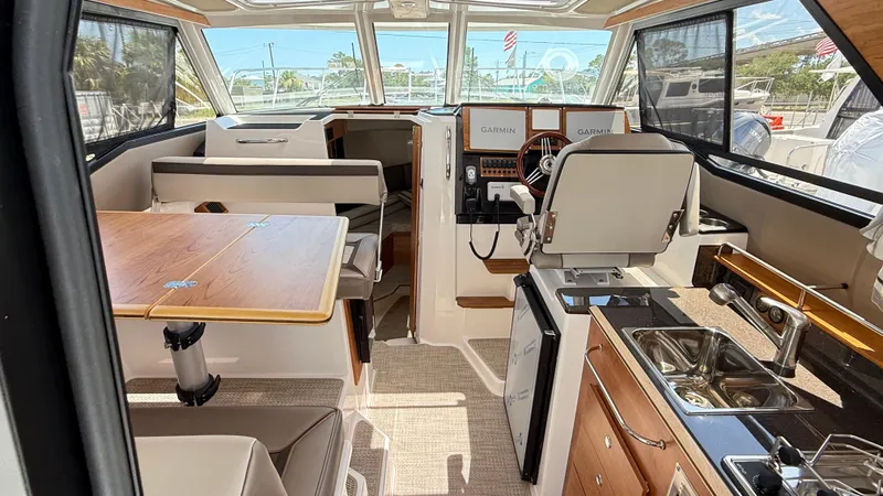  Yacht Photos Pics Interior of 2026 Cutwater C-288 Coupe, featuring helm, seating, and kitchenette.