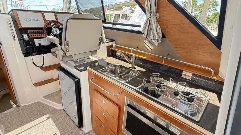  Yacht Photos Pics Interior of 2026 Cutwater C-288 Coupe featuring helm, kitchen, and modern appliances.