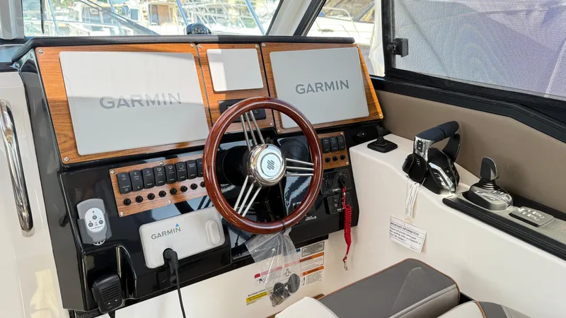  Yacht Photos Pics 2026 Cutwater C-288 Coupe helm with Garmin navigation and modern controls.