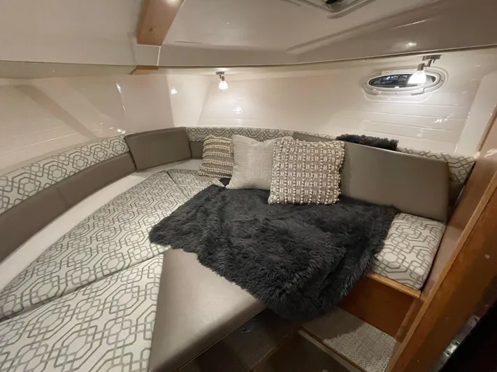  Yacht Photos Pics Luxurious interior of 2026 Cutwater C-288 Coupe with cozy bedding and stylish decor.