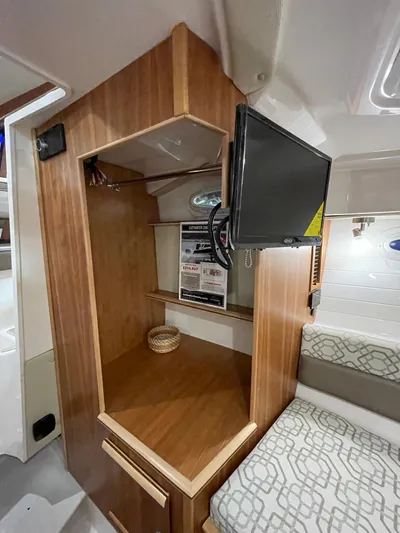  Yacht Photos Pics Interior of 2026 Cutwater C-288 Coupe with wooden cabinetry and mounted TV.