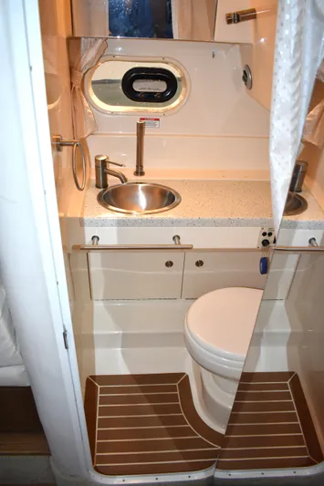  Yacht Photos Pics 2016 Sea Ray 310 Sundancer bathroom with sink, toilet, and porthole window.