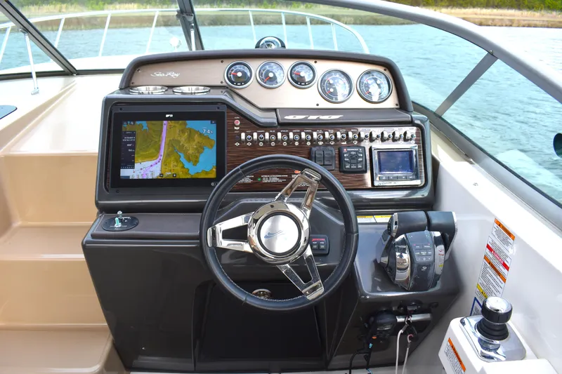  Yacht Photos Pics Cockpit of 2016 Sea Ray 310 Sundancer with navigation system and control panel.