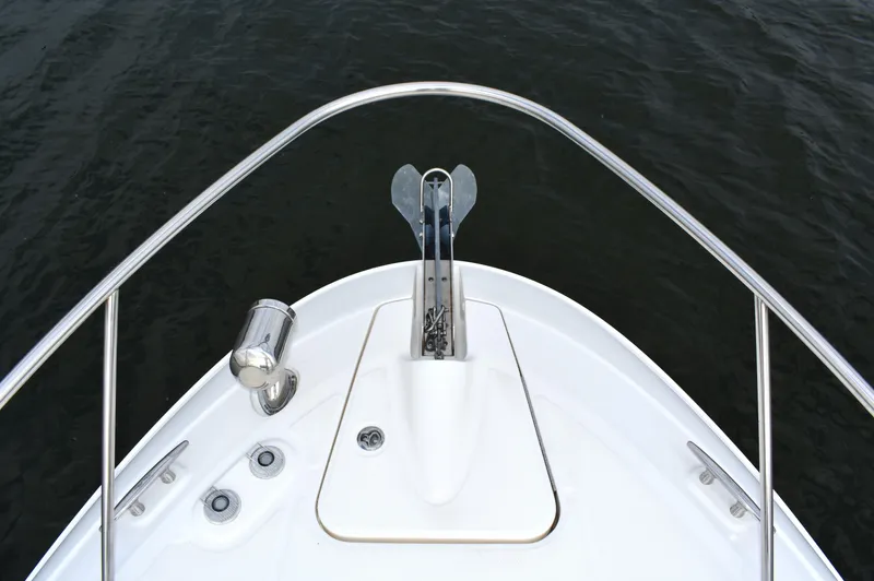  Yacht Photos Pics Bow of 2016 Sea Ray 310 Sundancer yacht with anchor, on calm water.