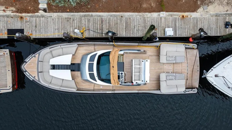  Yacht Photos Pics Aerial view of 2015 CNM 43 Continental yacht docked at a wooden pier.