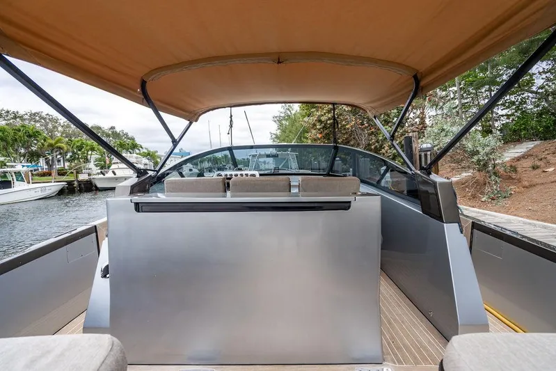  Yacht Photos Pics 2015 CNM 43 Continental yacht with canopy, docked in a serene marina setting.