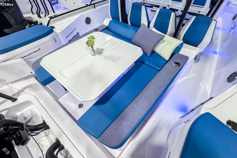  Yacht Photos Pics 2025 Axopar 37 Sun Top BRABUS Trim boat interior with blue seating and table.