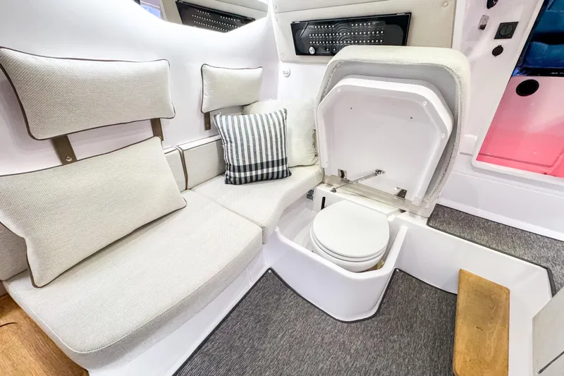  Yacht Photos Pics Luxurious interior of 2025 Axopar 37 Sun Top BRABUS Trim with seating and hidden toilet.