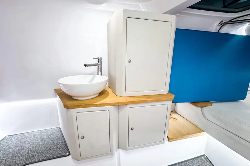  Yacht Photos Pics Modern interior of 2025 Axopar 37 Sun Top BRABUS Trim with sleek sink and cabinetry.
