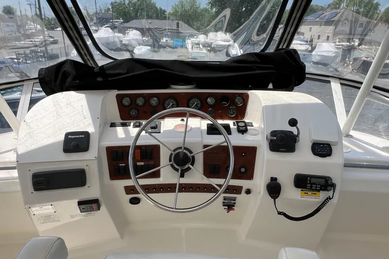 Sunflower Yacht Photos Pics 2002 Silverton 453 Motor Yacht helm with steering wheel, gauges, and navigation equipment.