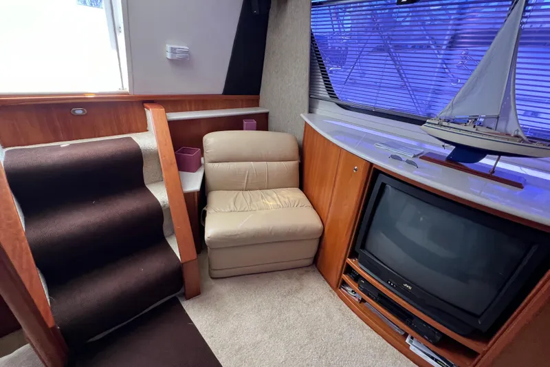 Sunflower Yacht Photos Pics Interior of 2002 Silverton 453 Motor Yacht with TV, chair, and model sailboat.