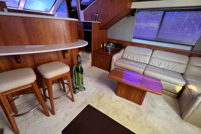 Sunflower Yacht Photos Pics Interior of 2002 Silverton 453 Motor Yacht with seating, table, and bar stools.
