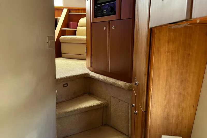 Sunflower Yacht Photos Pics Interior view of 2002 Silverton 453 Motor Yacht, featuring carpeted stairs and wooden cabinetry.