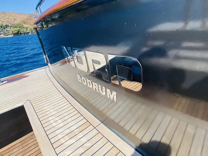  Yacht Photos Pics Ada Yacht Steel Trawler 2014, docked with "Bodrum" inscription, reflecting on calm water.
