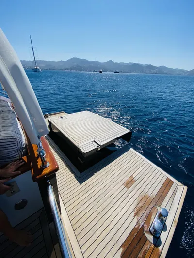  Yacht Photos Pics 2014 Ada Yacht Steel Trawler on serene blue waters with distant mountains.