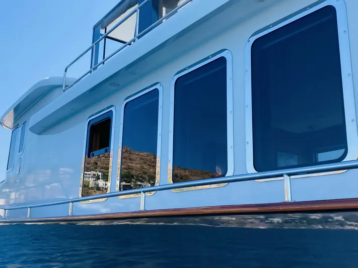  Yacht Photos Pics Ada Yacht Steel Trawler 2014, sleek design with large windows reflecting the sea.