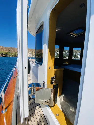  Yacht Photos Pics 2014 Ada Yacht Steel Trawler with open cabin door, docked by scenic waterfront.