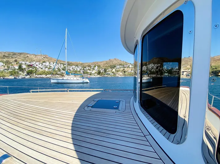  Yacht Photos Pics Ada Yacht Steel Trawler 2014 on serene water with scenic coastal backdrop.