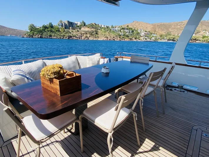  Yacht Photos Pics Outdoor dining area on 2014 Ada Yacht Steel Trawler, overlooking scenic coastal view.