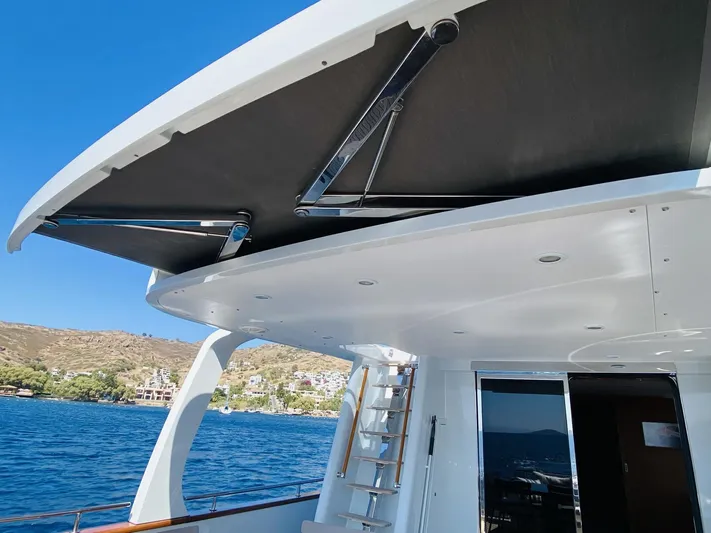  Yacht Photos Pics 2014 Ada Yacht Steel Trawler deck with retractable awning, ladder, and ocean view.