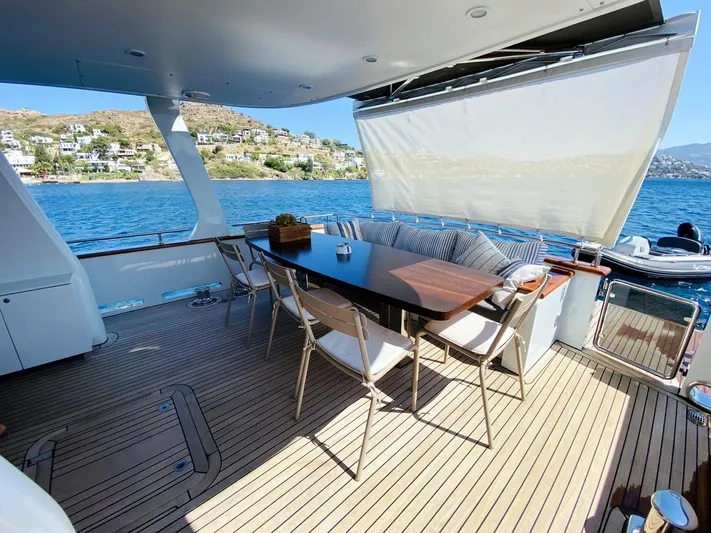  Yacht Photos Pics Outdoor seating area on 2014 Ada Yacht Steel Trawler, overlooking scenic waterfront.